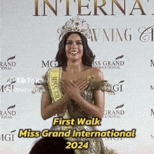 a woman wearing a crown and a sash that says miss grand international on it