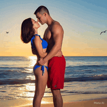 a man and woman kissing on a beach with meta al written in the corner