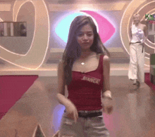 a woman in a red tank top with bianca written on it