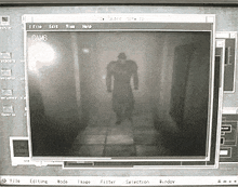 a computer screen shows a shadow of a man in a trench coat walking down a hallway