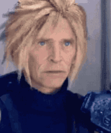 a man with a wig on his head is holding a gun and looking at the camera .