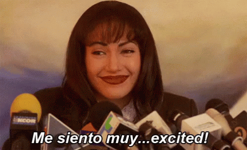 Gif of singer Selena Quintanilla in a press conference saying "Me siento muy... excited!" and giggling when she switches to English