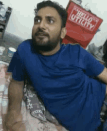 a man laying on a bed with a hello utility bag behind him