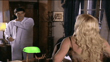 a man and a woman are looking at each other in a room