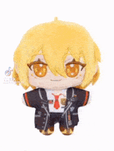 a stuffed toy of a boy with yellow hair and orange eyes is sitting on a table .
