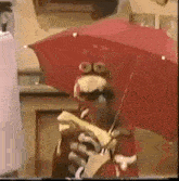 a cartoon character is holding a red umbrella and a banana .