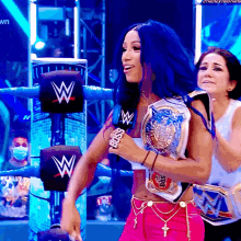 a woman in a wrestling ring is wearing a belt that says boss on it