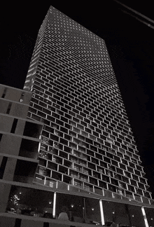 a black and white photo of a brick building at night
