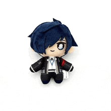 a stuffed toy of a boy with blue hair is sitting on a table .