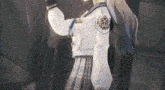 a girl in a school uniform has a badge on her sleeve