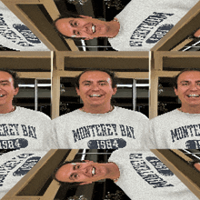 a man wearing a monterey bay 1984 sweatshirt smiles