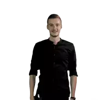 a man wearing a black shirt is standing with his arms outstretched