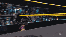 a woman in a wrestling ring with the words # 20live on the bottom