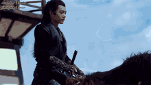 a man is riding a horse with a sword in his hand