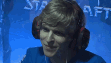 a man wearing headphones holds his hands to his face