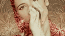 a woman is covering her mouth with her hands while looking at the camera .