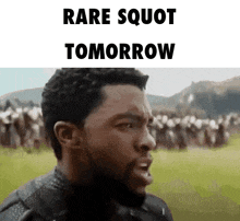 a man with a beard is standing in front of a crowd of people with the words rare squat tomorrow written above him .