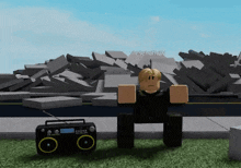 a roblox character is sitting on the grass next to a radio .