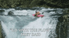 a man in a kayak is going through a waterfall with the words go with the flow they said