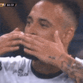 a man covering his mouth with his hands while wearing a shirt that says " pro vital "