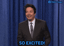 a man in a suit says so excited in front of a paw chain logo