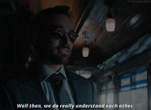 a man in a suit and tie is saying " well then we do really understand each other "