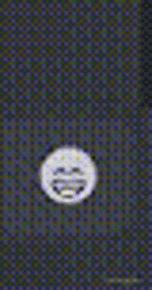 a yellow smiley face is sitting on top of a purple and blue checkered background .