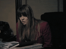 a woman sitting at a desk with the words where the fuck is it on the bottom