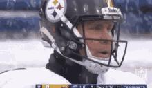 a close up of a football player wearing a helmet with the word steelers on it