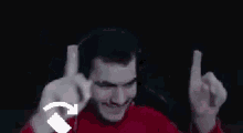 a man wearing headphones and gloves is making a funny face .