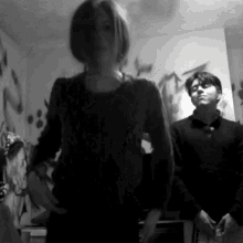 a black and white photo of a man and woman