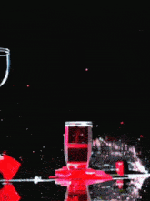 a woman is holding a glass of red wine next to a bunch of grapes