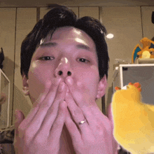 a man with a ring on his finger kisses his lips