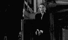 a woman is talking on a cell phone in a black and white photo .