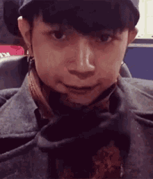 a close up of a person 's face with a scarf around their neck .