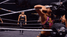 a woman in a wrestling ring with the word championship on the bottom