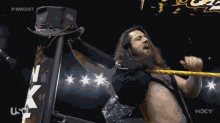 a man in a wrestling ring with the word nxt in the corner