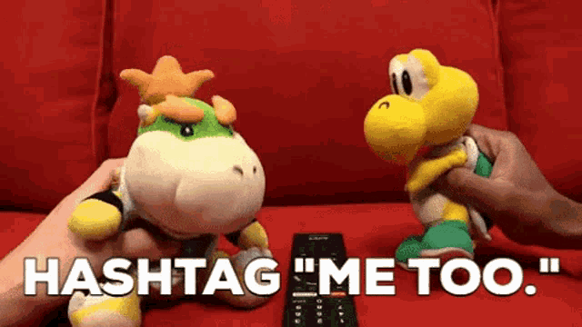 a person is holding a remote control next to two stuffed animals that say hashtag me too