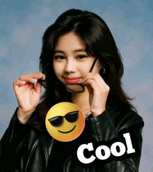 a woman wearing sunglasses and a smiley face with the word cool below her