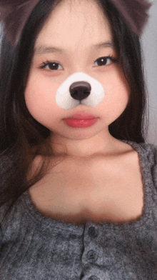 a girl with a dog face painted on her nose