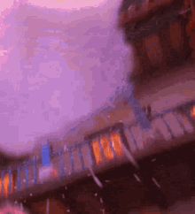 a blurred image of a bridge with a purple sky in the background