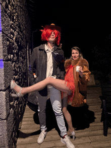 a man in a cowboy hat and a woman in a fur coat are posing for a photo