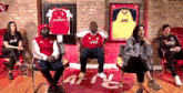 a group of people are sitting in chairs in front of a sign that says aftv