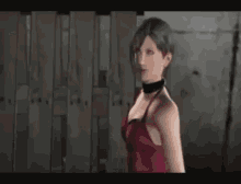 a woman in a red dress is holding a gun in her hand .