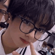 a close up of a person wearing glasses and making a funny face .