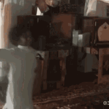 a person is standing in a room with a clock in the background