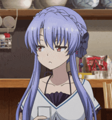 a girl with blue hair and red eyes is holding a card in her hand