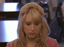 a close up of a woman 's face with blonde hair and earrings