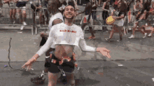 a man in a crop top that says bad habit on it