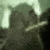 a blurry picture of a person holding a sword